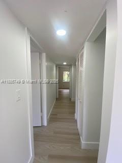 241 Wimbledon Lakes Drive, Unit 241 Plantation, FL 33324 - Photo 10 of 16 a view of a hallway with wooden floor