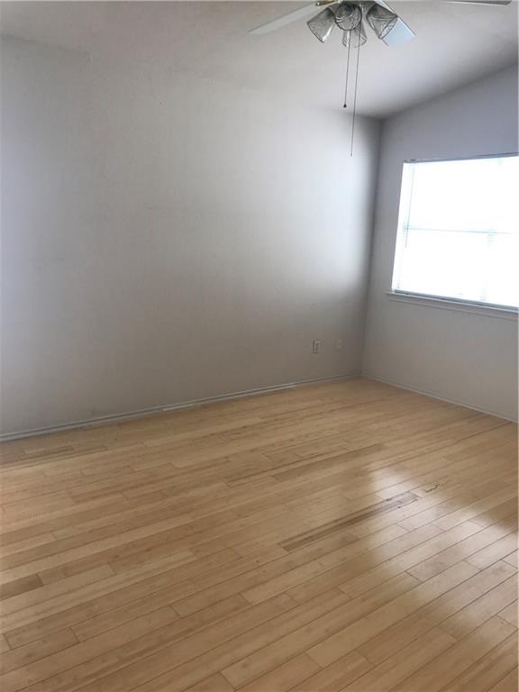 8337 Alvin High Lane Austin, TX 78729 - Photo 11 of 14 Unfurnished room with a ceiling fan and light wood finished floors