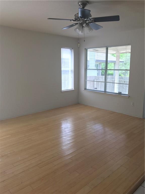 8337 Alvin High Lane Austin, TX 78729 - Photo 2 of 14 Empty room featuring light wood finished floors and ceiling fan