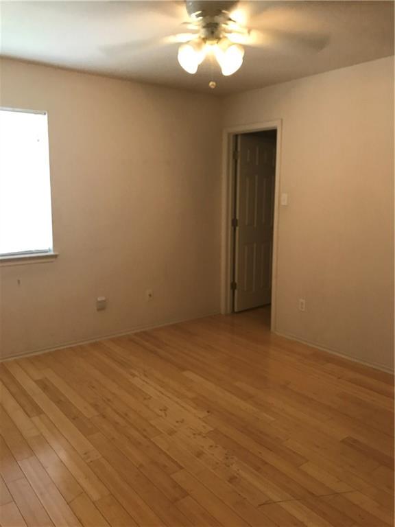 8337 Alvin High Lane Austin, TX 78729 - Photo 10 of 14 Unfurnished room featuring light wood-style flooring and a ceiling fan