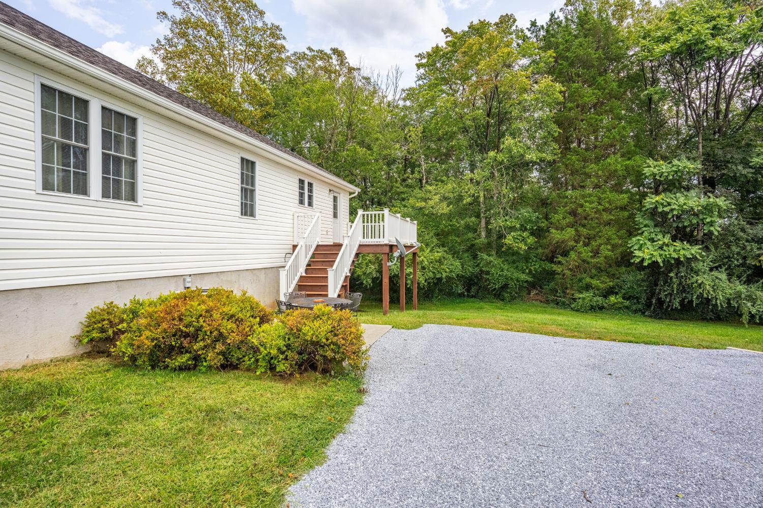 233 View Lane Concord, VA 24538 - Photo 28 of 45 a view of a backyard with couches under an umbrella