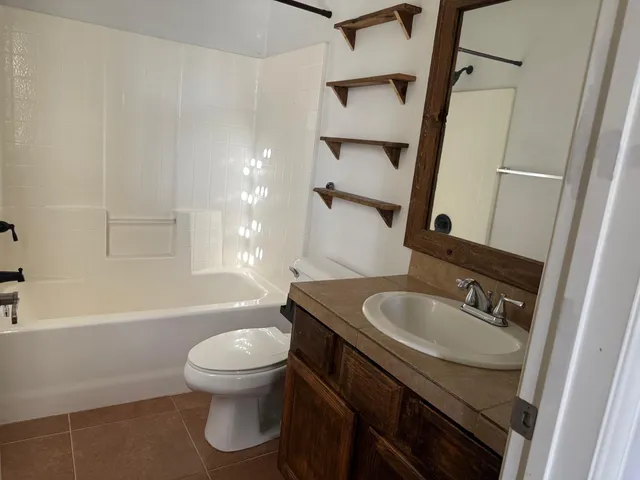 a view of a backyard with a tree