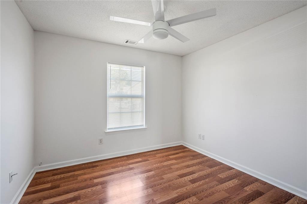 6132 Christopher Terrace Rex, GA 30273 - Photo 19 of 40 an empty room with wooden floor and windows