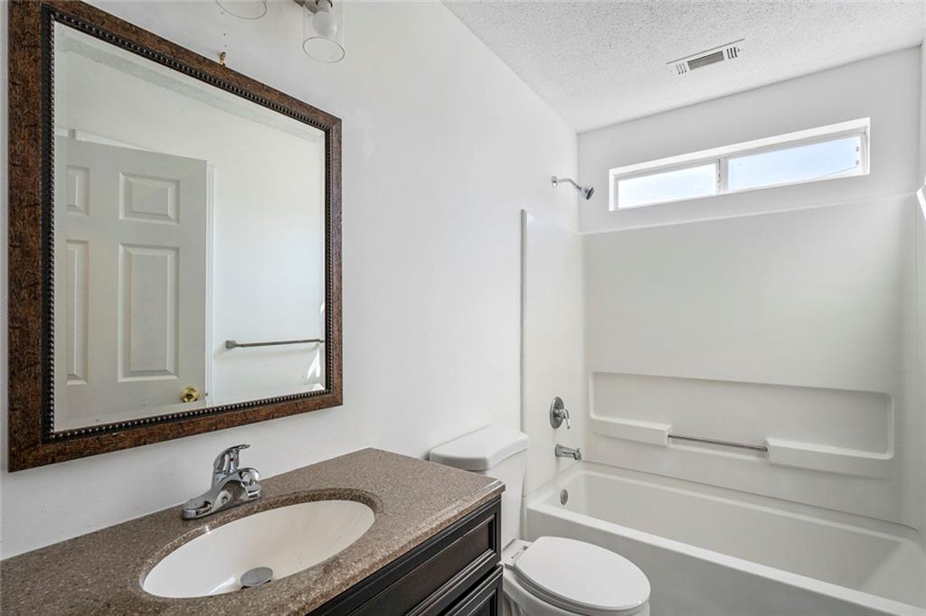 6132 Christopher Terrace Rex, GA 30273 - Photo 21 of 40 a bathroom with a granite countertop sink toilet and a mirror