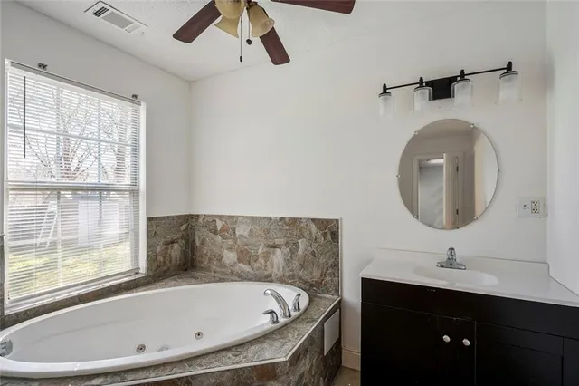 a bathroom with a bathtub and a sink