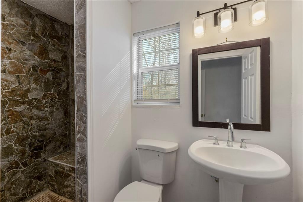 6132 Christopher Terrace Rex, GA 30273 - Photo 33 of 40 a bathroom with a toilet sink and mirror