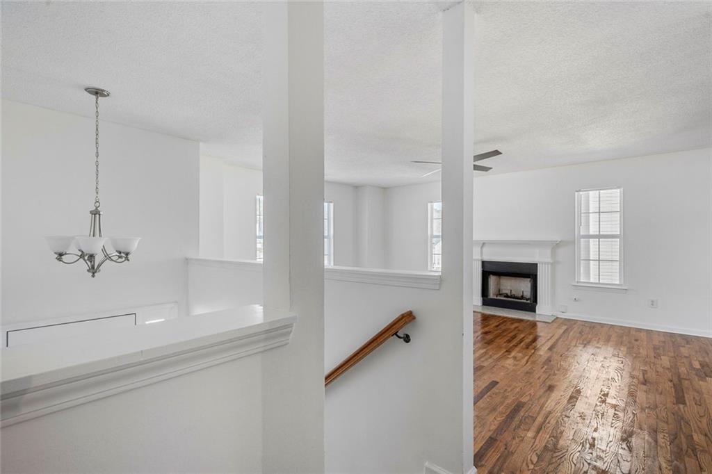 6132 Christopher Terrace Rex, GA 30273 - Photo 4 of 40 a view of empty room with fireplace and wooden floor