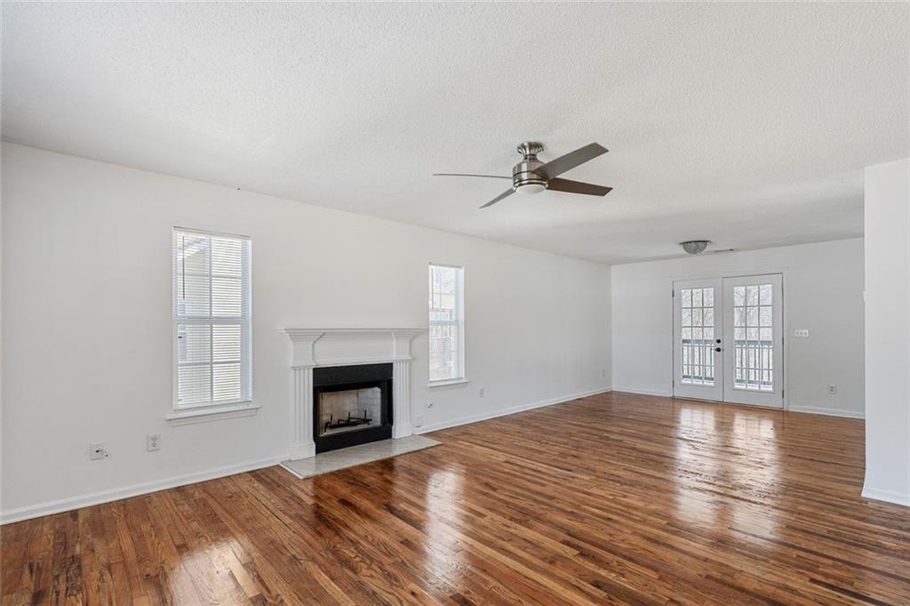 6132 Christopher Terrace Rex, GA 30273 - Photo 5 of 40 an empty room with windows and fireplace