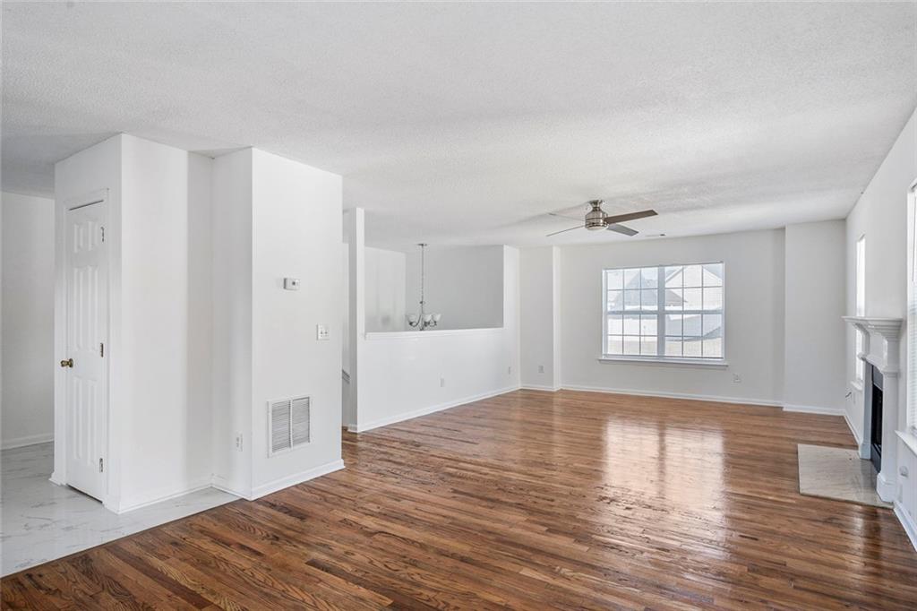 6132 Christopher Terrace Rex, GA 30273 - Photo 8 of 40 a view of an empty room with wooden floor and a window
