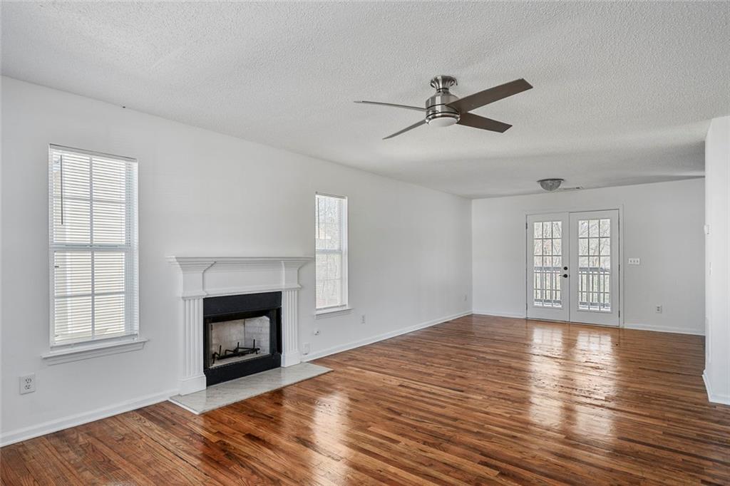 6132 Christopher Terrace Rex, GA 30273 - Photo 9 of 40 a view of empty room with wooden floor and fireplace