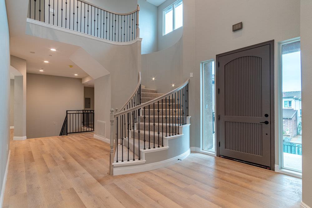 6565 Eagle Ridge Court Gilroy, CA 95020 - Photo 5 of 57 a view of a hallway with wooden floor and windows