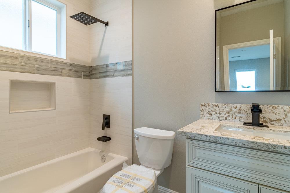 6565 Eagle Ridge Court Gilroy, CA 95020 - Photo 55 of 57 a bathroom with a granite countertop sink a toilet and bathtub