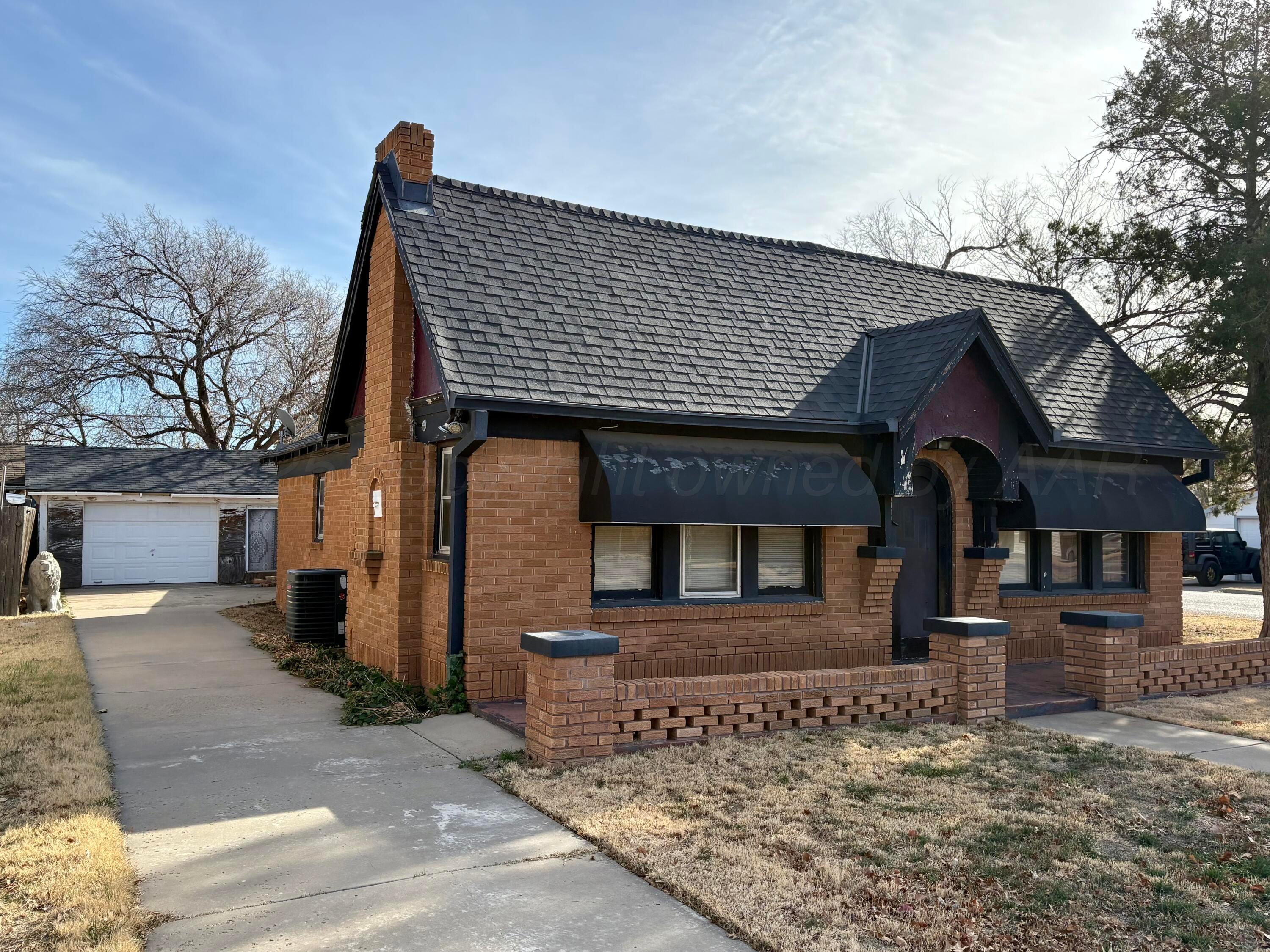 3209 South Harrison Street Amarillo, TX 79109 - Photo 2 of 4 a front view of a house with garden
