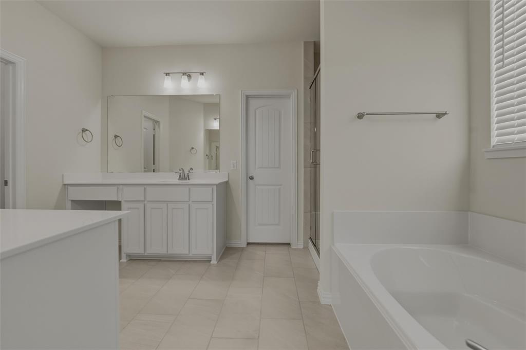 1113 Trinity Drive Springtown, TX 76082 - Photo 26 of 40 White shaker-style vanity with a single sink and large mirror