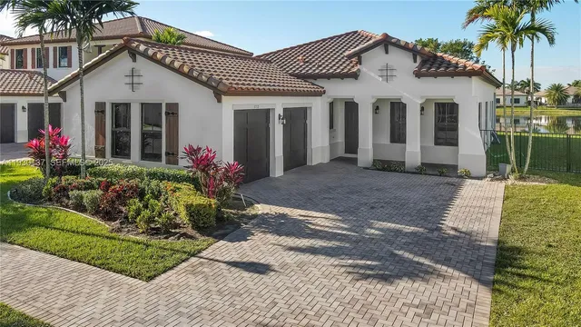 a front view of a house with a garden
