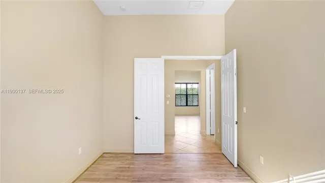 a view of a hallway with wooden floor