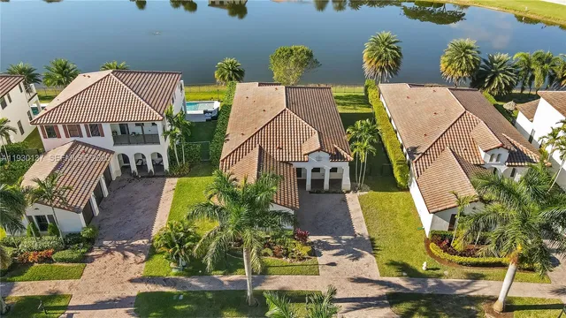 an aerial view of a house with swimming pool and patio