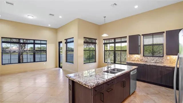 a kitchen with granite countertop a sink and a stove