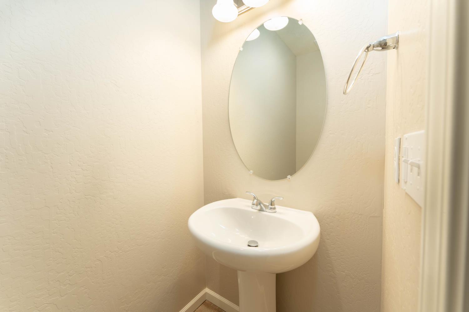 30480 Bellwood Road Visalia, CA 93291 - Photo 16 of 37 a bathroom with a sink and mirror