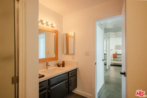 a bathroom with a sink a mirror and a shower