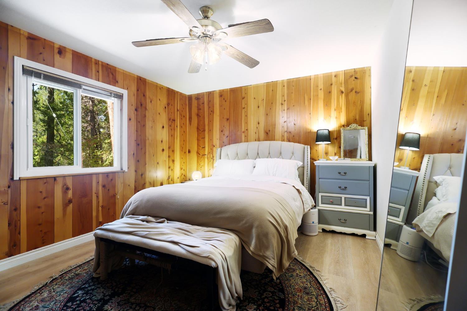 21800 Cedar Ridge Road Manton, CA 96059 - Photo 11 of 35 a bedroom with a bed and a chandelier