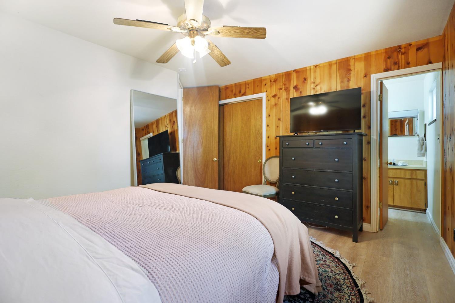 21800 Cedar Ridge Road Manton, CA 96059 - Photo 12 of 35 a bedroom with a bed and a flat tv screen on dresser