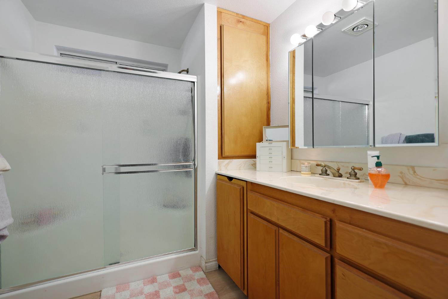 21800 Cedar Ridge Road Manton, CA 96059 - Photo 23 of 35 a bathroom with a granite countertop sink mirror and shower