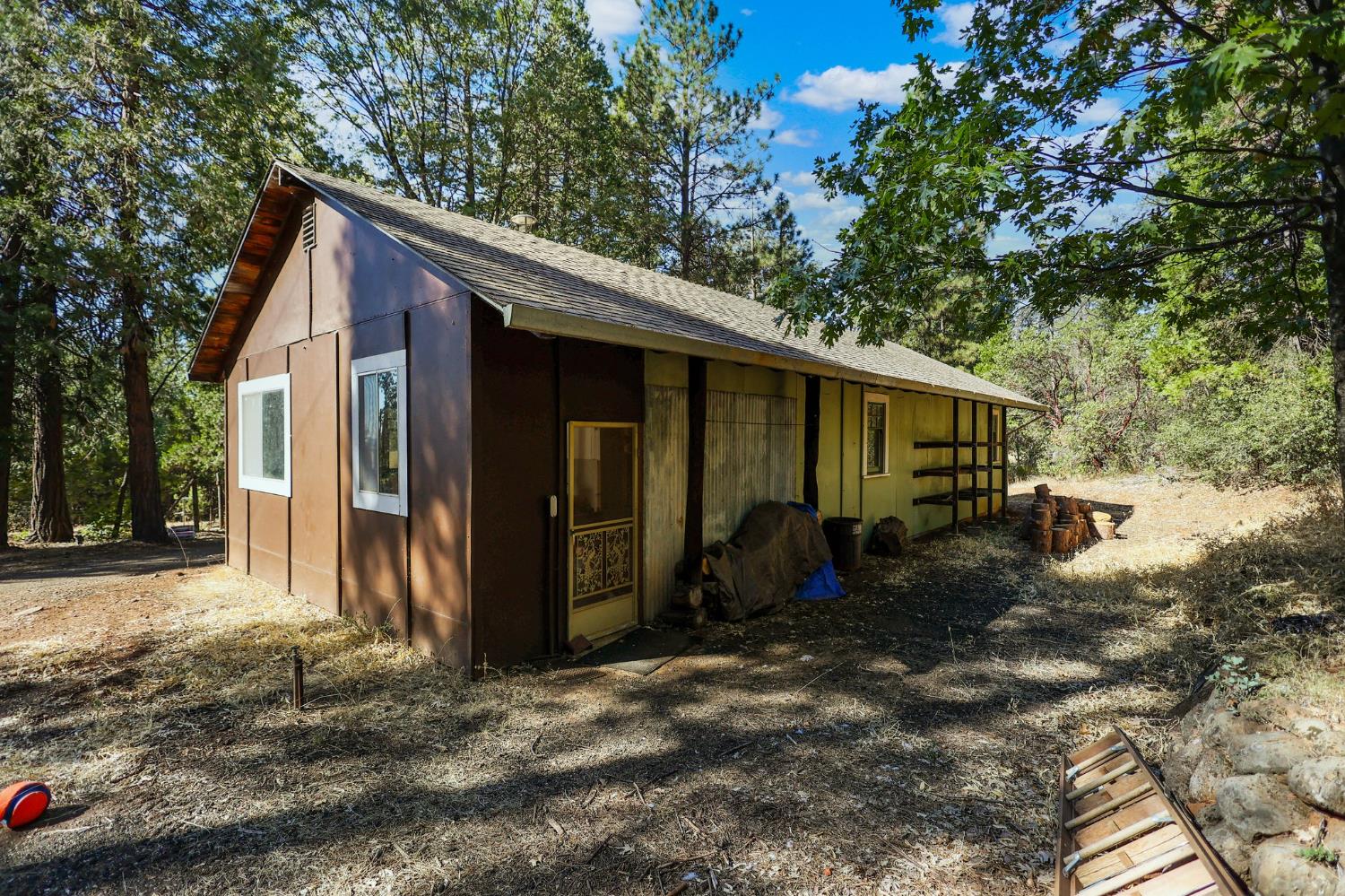 21800 Cedar Ridge Road Manton, CA 96059 - Photo 33 of 35 a backyard of a house with yard fire pit barbeque oven and covered with tall trees