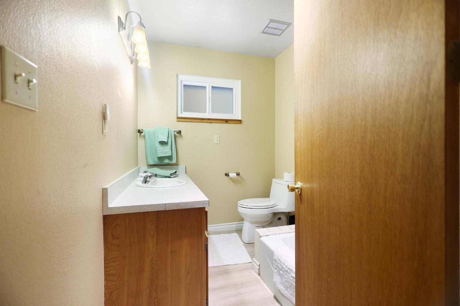 21800 Cedar Ridge Road Manton, CA 96059 - Photo 10 of 35 a bathroom with a toilet a sink and mirror