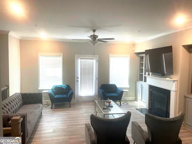 a living room with furniture a fireplace and a flat screen tv