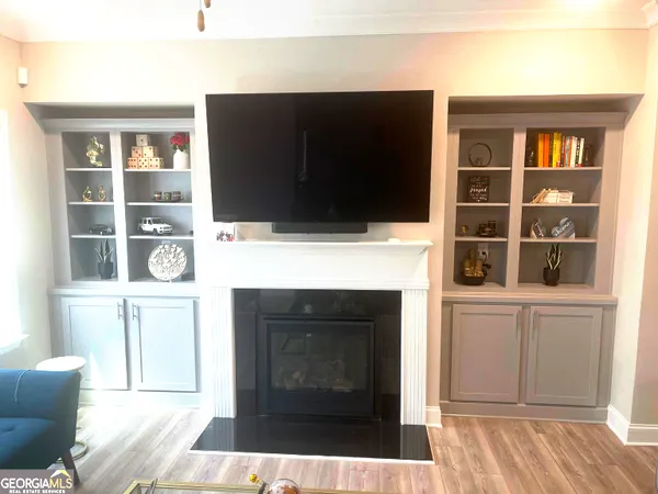 a living room with a fireplace and a flat screen tv