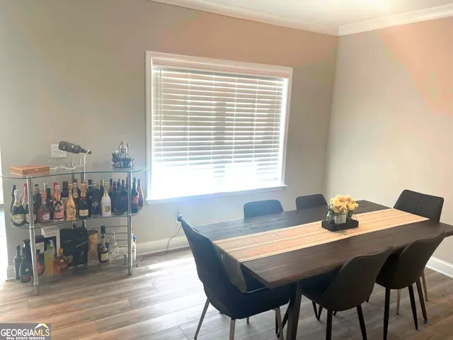 a dining room with furniture and wooden floor