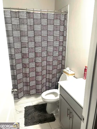 a bathroom with a toilet and a shower