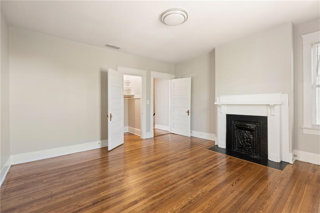 120 South Candler Street Decatur, GA 30030 - Photo 24 of 40 a view of an empty room with wooden floor fireplace and a window