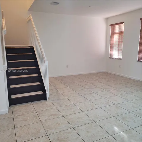 a kitchen with a refrigerator a microwave and cabinets