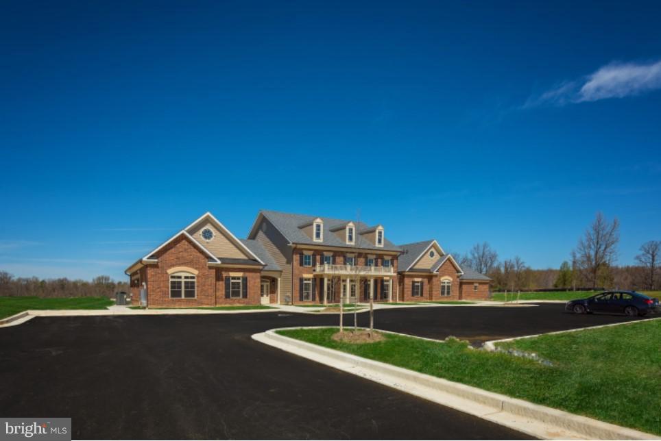 7848 Brandy Station Road, Unit MOZART Hanover, MD 21076 - Photo 20 of 27 a front view of a house with a yard