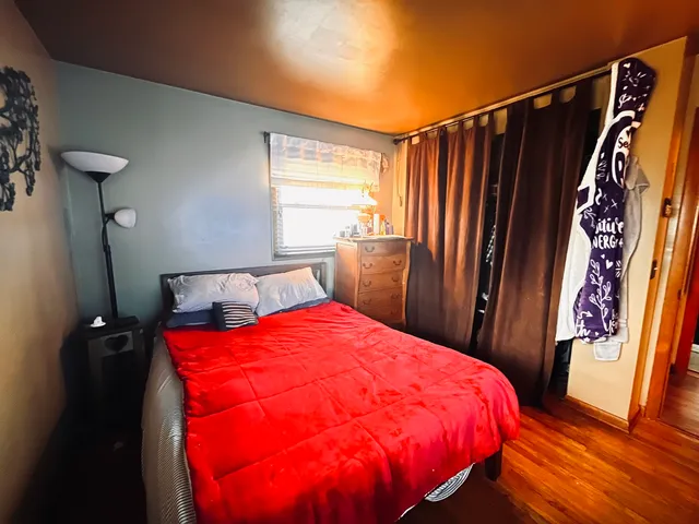 a bed sitting in a bedroom next to a window