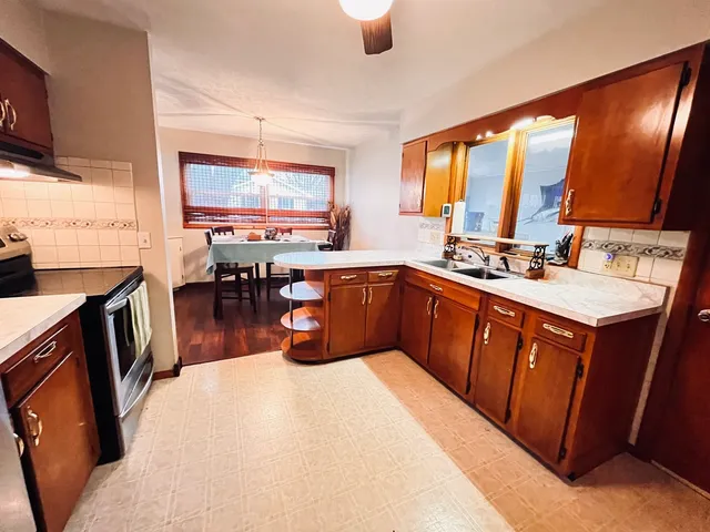 a kitchen with a sink a counter top space and stainless steel appliances