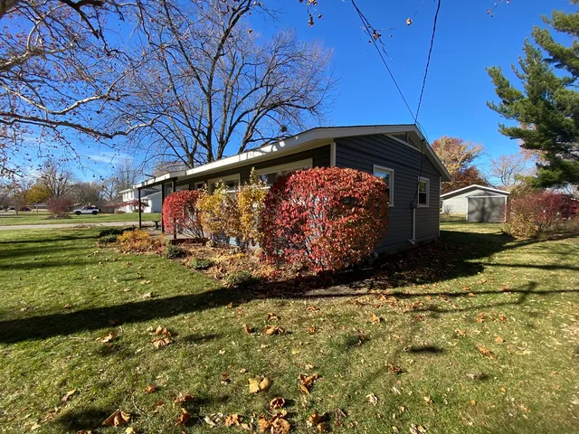 a view of a yard with yellow house