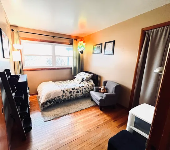 a bedroom with furniture and a window