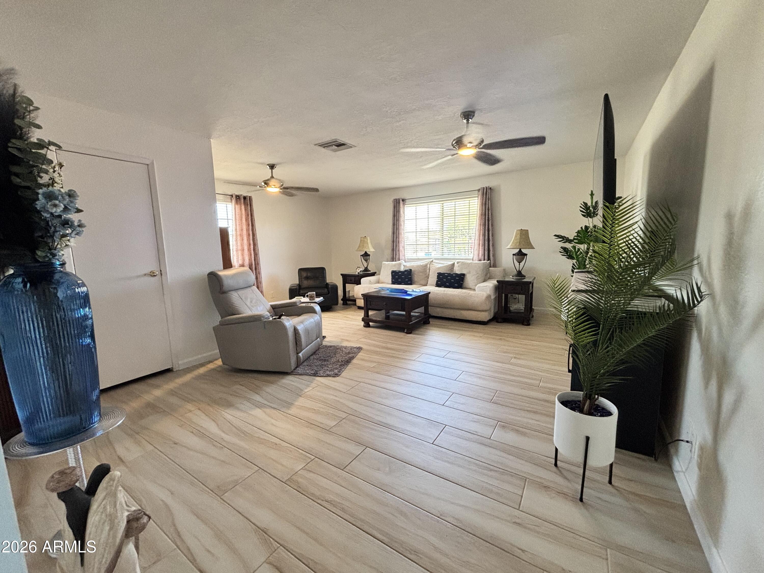 7745 East Mangun Road Mesa, AZ 85207 - Photo 23 of 35 a living room with furniture windows and wooden floor