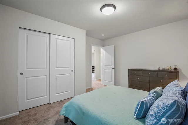 a bedroom with a bed and cabinets