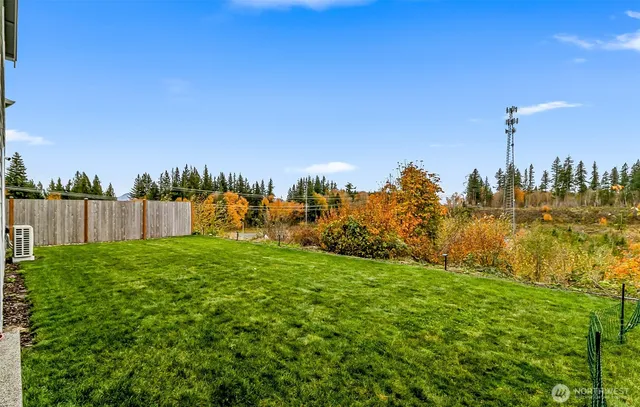 a view of a garden with a house in the background