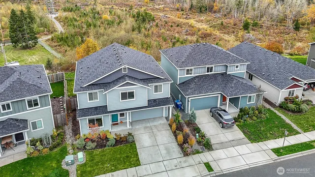 an aerial view of a house with a yard