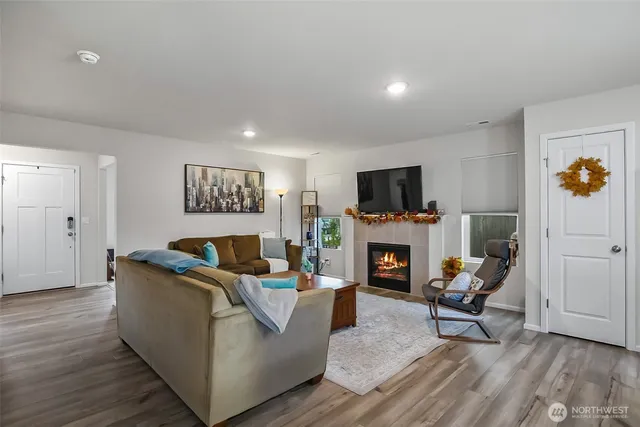 a living room with furniture a fireplace and a flat screen tv