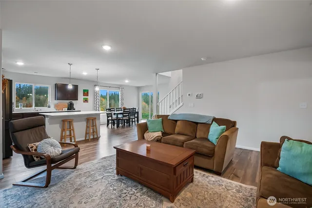 a living room with furniture and kitchen view