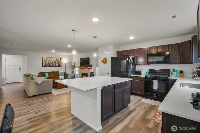 a large kitchen with stainless steel appliances lots of counter top space