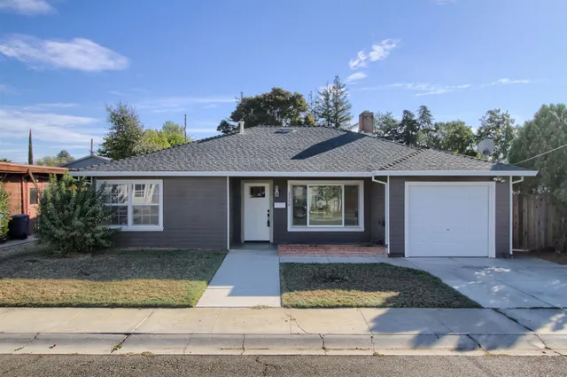 a front view of a house with garden