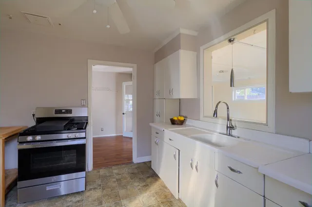 a kitchen with stainless steel appliances a stove and a sink