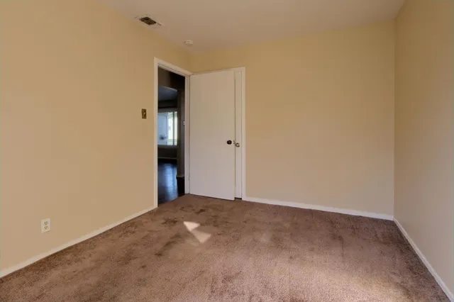a view of an empty room and a window